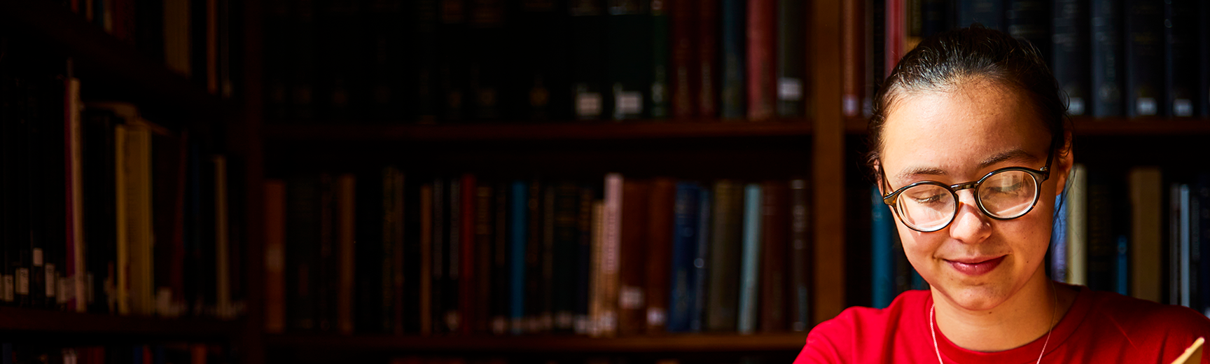 A person reading a book in an Oxford library