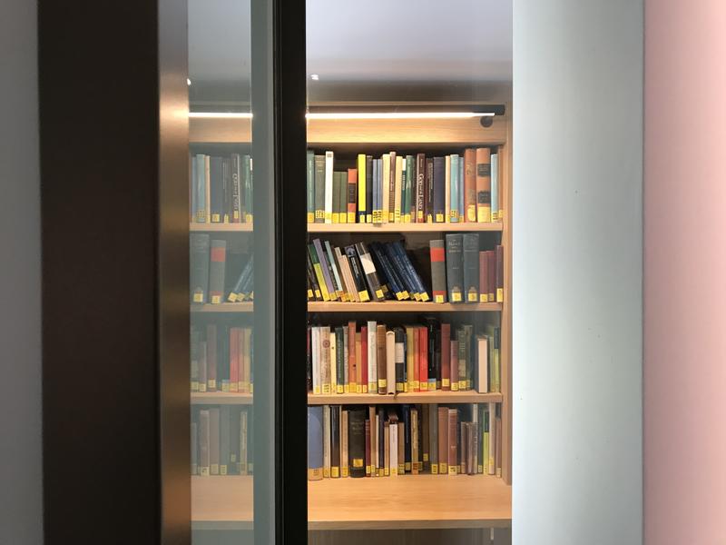 Book shelf - Credit: Shutterstock A view from an open glass door of books on a shelf