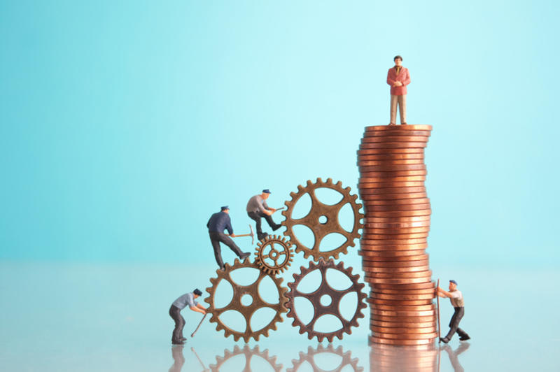 Men climbing a notional pile of money in a depiction of capitalism Men climbing a notional pile of money in a depiction of capitalism