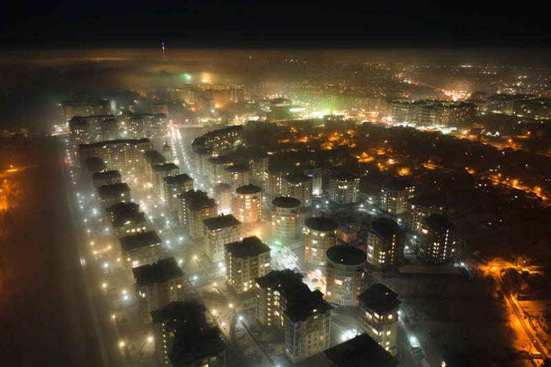 Aerial view of high rise apartment buildings and bright illuminated streets in Ivano-Frankivsk city, Ukraine residential area at night. Dark urban landscape Aerial view of high rise apartment buildings and bright illuminated streets in Ivano-Frankivsk city, Ukraine residential area at night. Dark urban landscape
