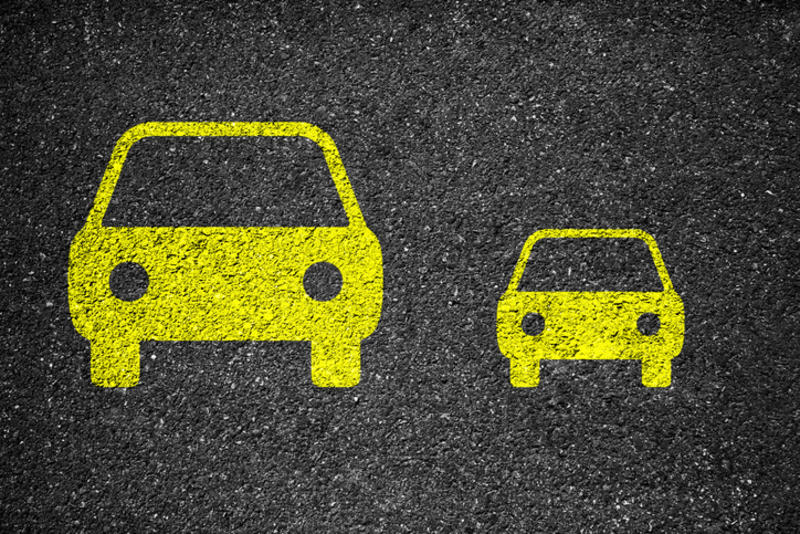Image of a large and small car painted on asphalt Image of a large and small car painted on asphalt