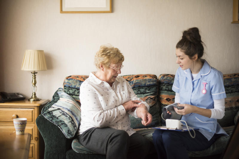 A resident being treated by a nurse in a UK Care Home A resident being treated by a nurse in a UK Care Home
