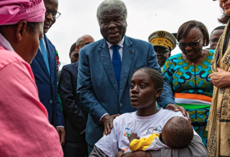 The first recipient of the R21 malaria vaccine, pictured with officials
