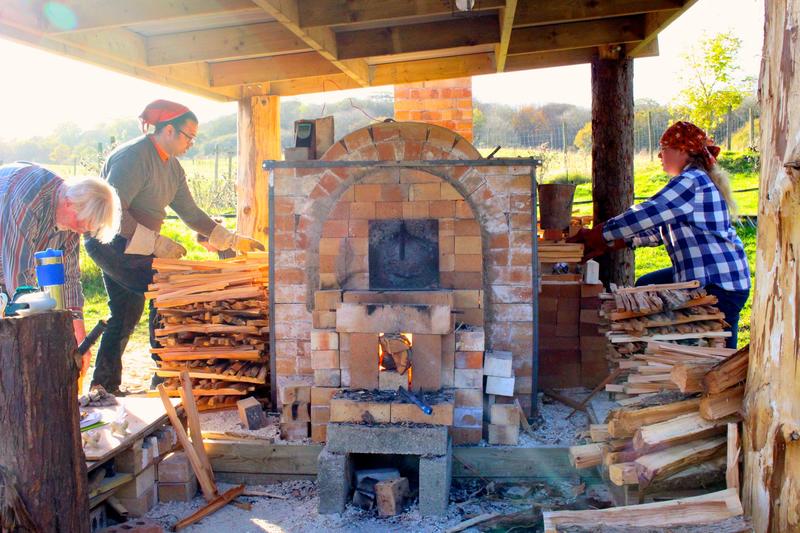 Volunteers working around the anagama kiln