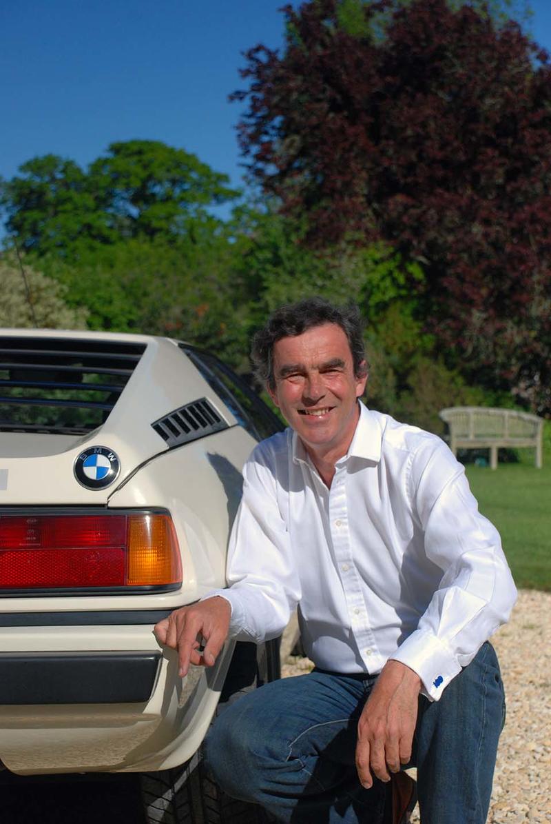 Eric Verdon Roe - Credit: University of Oxford/Richard Lofthouse Eric Verdon Roe crouched at the rear of a white BMW M1