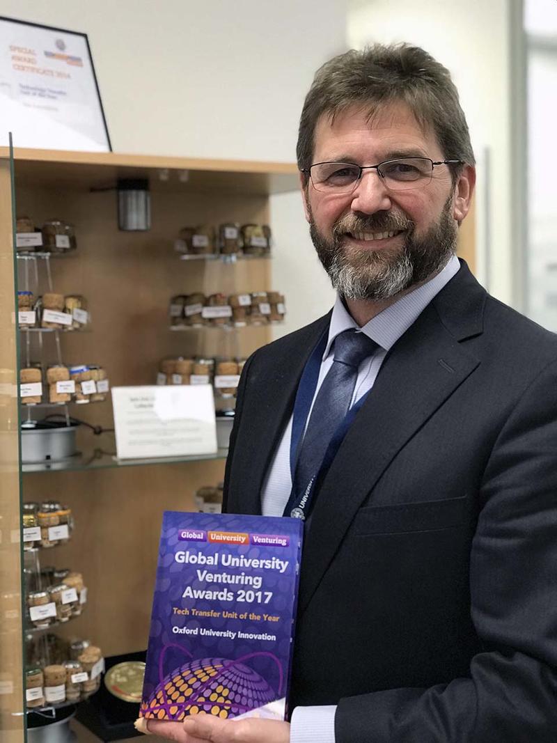 Matt Perkins holding OUI's Tech Transfer Unit of the Year 2017 Award