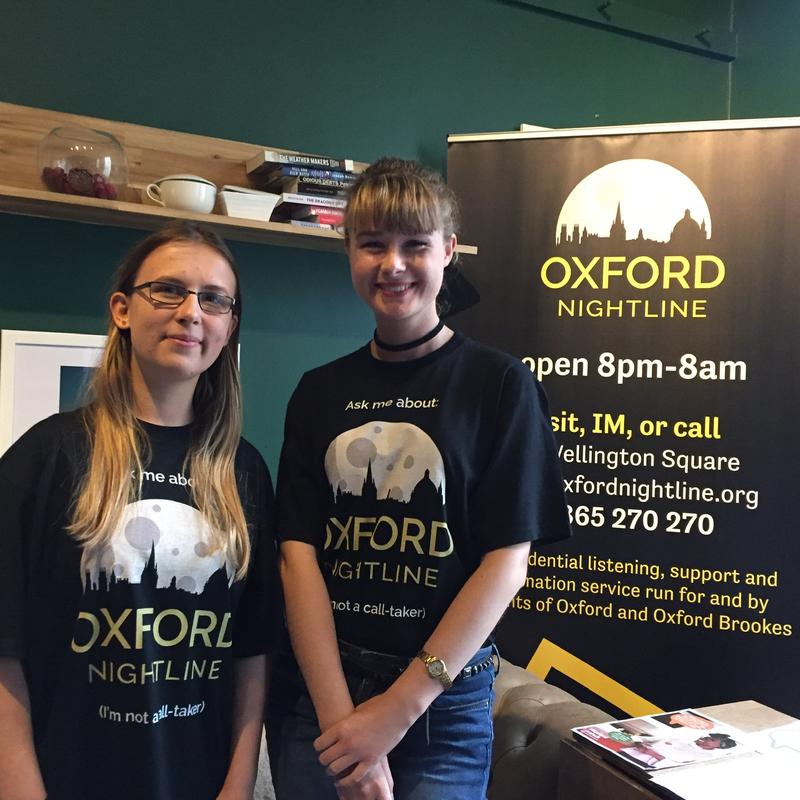 Two female Nightline volunteers at a fresher's fair event