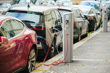 An electric car shown charging in the high street An electric car shown charging in the high street