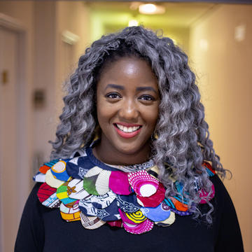 Anne-Marie Imafidon smiling in a corridor outside STEMettes HQ Anne-Marie Imafidon smiling in a corridor outside STEMettes HQ